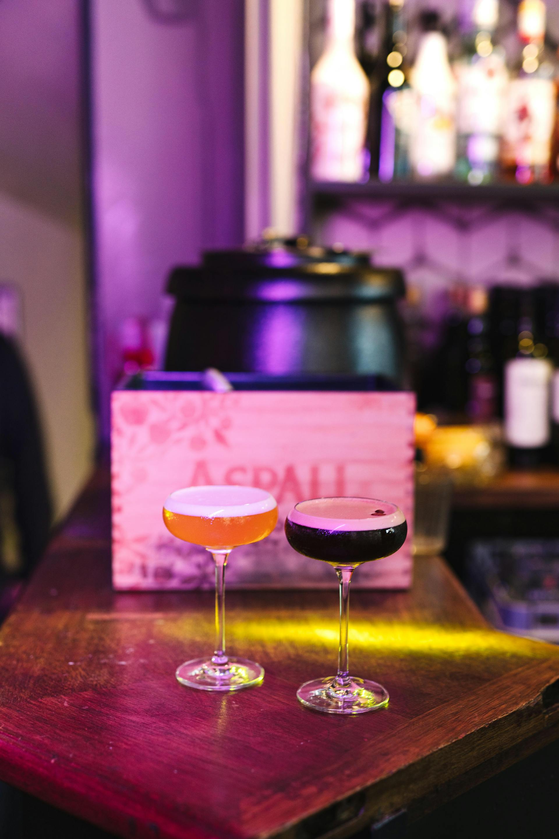 Two coupe cocktails on the bar — Oud Old Fashioned pair